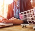 cropped-image-woman-inputting-card-information-key-phone-laptop-while-shopping-online_-----------x---