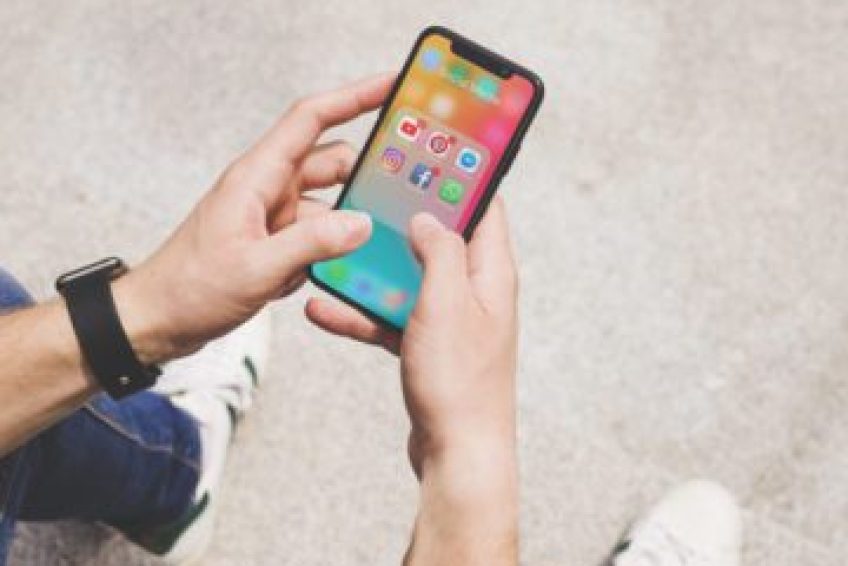 overhead-view-man-s-hand-using-social-media-app-mobile_-----------------x---