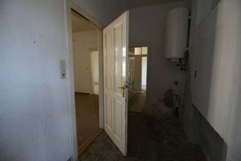 inside an old lost house with a hole in the wall